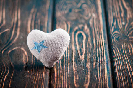 Heart made of cloth on wood desk. Valentine day. Holidays card with copy spaceの写真素材