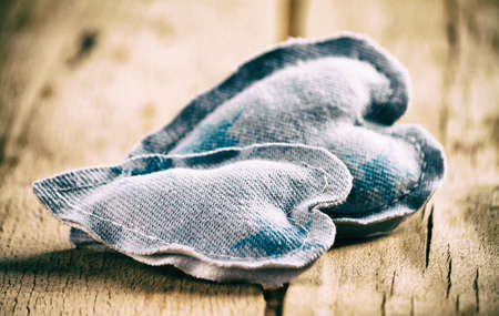 Heart made of cloth on wood desk. Valentine day. Holidays card with copy spaceの写真素材