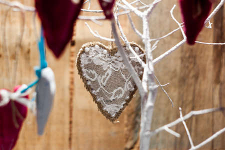 Heart made of cloth on white branch. Valentine day. Holidays card with copy spaceの写真素材