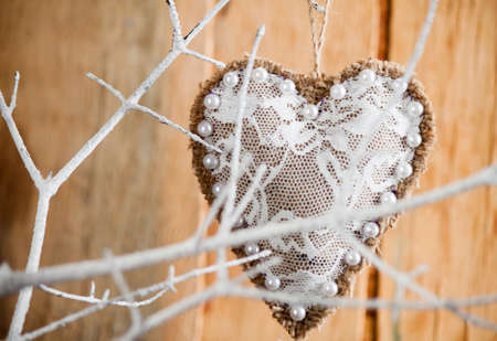 Heart made of cloth on white branch. Valentine day. Holidays card with copy spaceの写真素材