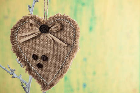 Heart from clothing on wood branch. Valentines day. International Women's Dayの写真素材