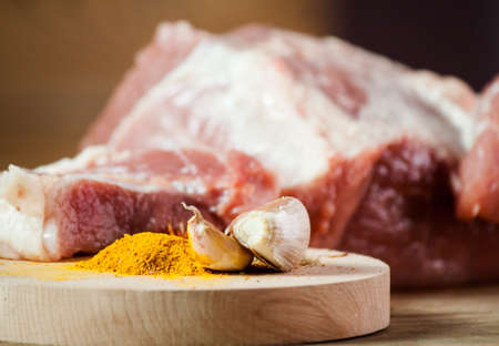 Piece of meat and  seasoning  on wood desk. Food ingredientsの写真素材