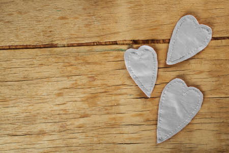 Heart made of cloth on wood desk. Valentine day. Holidays card with copy spaceの写真素材