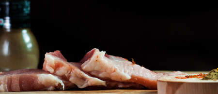 Piece of meat and seasoning on wood desk. Food ingredientsの写真素材