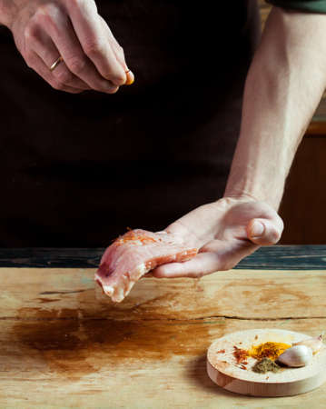 Butcher cutting pork meat on kitchen. Food backgroundの写真素材