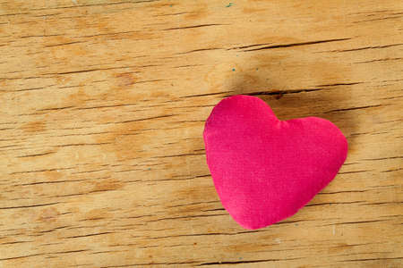 Heart from cloth on wood desk. Valentines day backgroundの写真素材