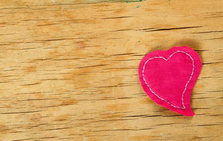 Heart from cloth on wood desk. Valentines day backgroundの写真素材