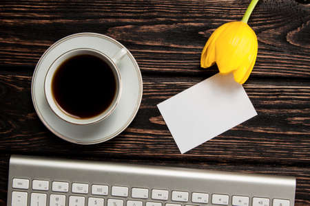 Fresh color tulip and keyboard on wood desk. Spring flowerの写真素材