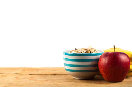 Muesli in bowl and fresh fruits with measuring tape isolated on white backgroundの写真素材
