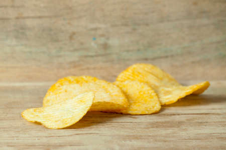 Fried potato chips corrugated on wood desk. Foodの写真素材