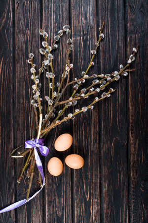 willow branch on wood background and egg. Happy easterの写真素材