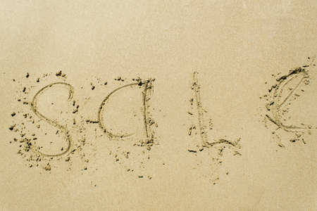 Inscription SALE on sand. Nature background. Beachの写真素材
