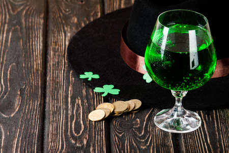 Happy St. Patrick's Day green drink and cake on wood desk