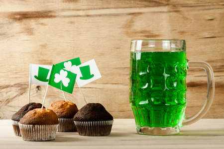 Happy St. Patrick's Day green drink and cake on wood deskの写真素材