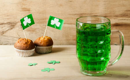Happy St. Patrick's Day green drink and cake on wood deskの写真素材