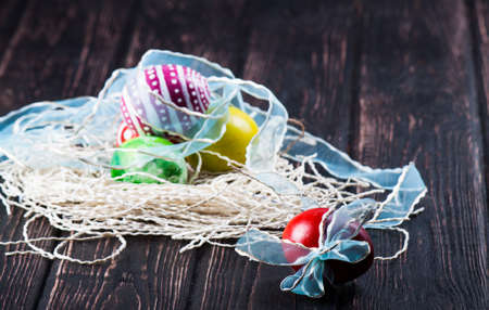 Colorful easter eggs close up on wood deskの写真素材
