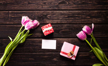 Fresh color tulips on wood desk. Nature backgroundの写真素材