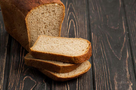 Fresh bread isolated on wood background. Bakingの写真素材