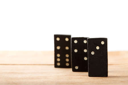 Chain of black dominoes isolated on white backgroundの写真素材