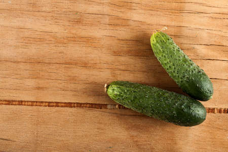 Ripe fresh cucumber on wood desk. Food backgroundの写真素材
