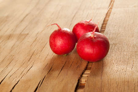 Ripe fresh radish on wood desk. Food backgroundの写真素材