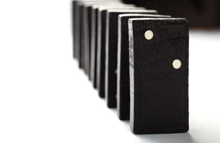 Chain of black dominoes isolated on white backgroundの写真素材