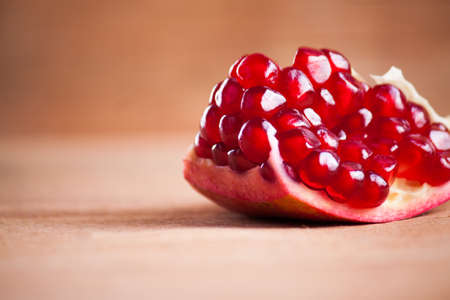 Fresh ripe pomegranate close up on wood desk. Food backgroundの写真素材
