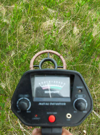 Metal detector in operation in nature close up.の写真素材