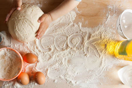 Kitchen table with ingredients for preparing dough. Cookingの写真素材