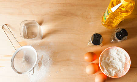 Kitchen table with ingredients for preparing dough. Cookingの写真素材