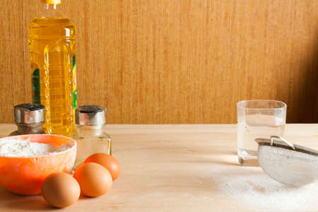 Kitchen table with ingredients for preparing dough. Cookingの写真素材