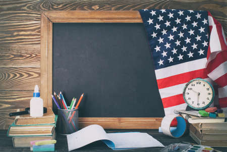 Blackboard and office  tools on wood table. Education concept.の写真素材