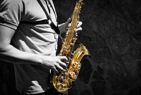 Man playing on saxophone. Education concept. Music backgroundの写真素材