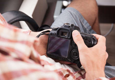 Photographer with camera in hand looking through the camera lensの写真素材