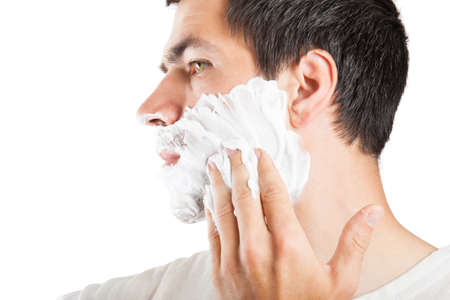 The man is applying a shaving foam. Skin careの写真素材