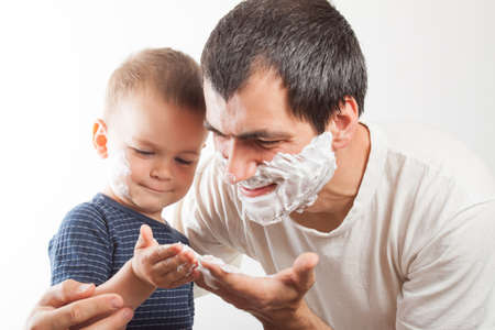 Dad teaches his son to shave. Family relationships. Educationの写真素材