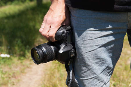 Man photographer with camera in nature. Proffesion conceptの写真素材