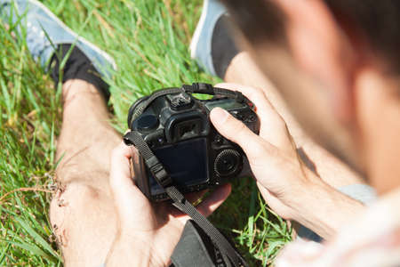 Man photographer with camera in nature. Proffesion conceptの写真素材