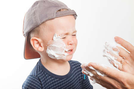 Dad teaches his son to shave. Family relationships. Educationの写真素材