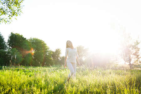 Young woman outdoors portrait. Soft sunny colors.の写真素材