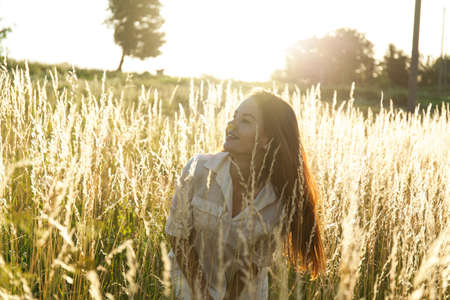 Young woman outdoors portrait. Soft sunny colors.の写真素材