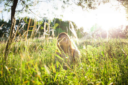 Young woman outdoors portrait. Soft sunny colors.の写真素材