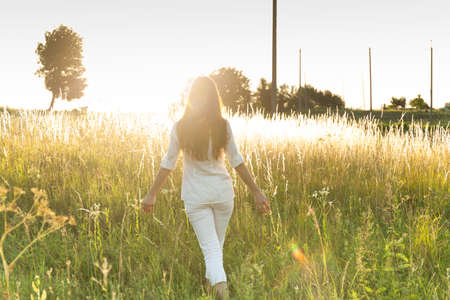 Young woman outdoors portrait. Soft sunny colors.の写真素材