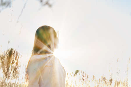 Young woman outdoors portrait. Soft sunny colors.の写真素材