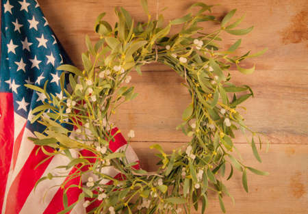Christmas wreath with mistletoe on wood board. Christmas decoration.の写真素材