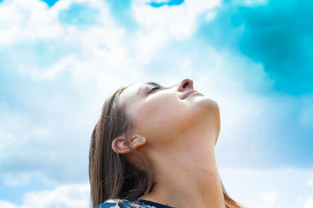 Fashion beautiful girl in the field with bouquet of wildflowersの写真素材