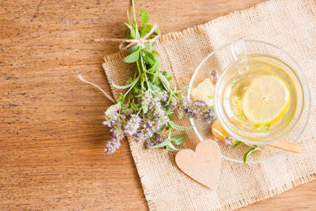 Herbal tea from lemon balm on wood tableの写真素材