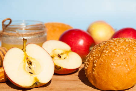 Symbols of the Jewish New Year. Apple, honey, Shofar, challah close up.の写真素材
