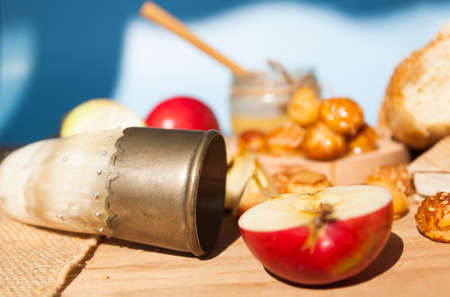 Symbols of the Jewish New Year. Apple, honey, Shofar, challah close up.の写真素材