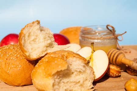 Symbols of the Jewish New Year. Apple, honey, Shofar, challah close up.の写真素材